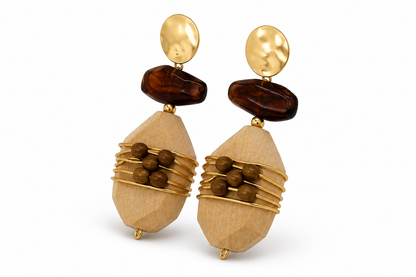 A pair of bohemian-style drop earrings featuring faceted light wood beads wrapped in gold wire, dark brown stone accents, and hammered gold circular studs, shown on a white background.